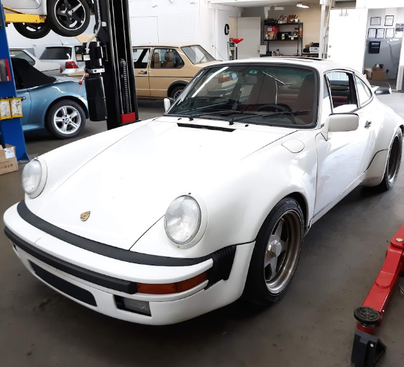 white car on auto shop